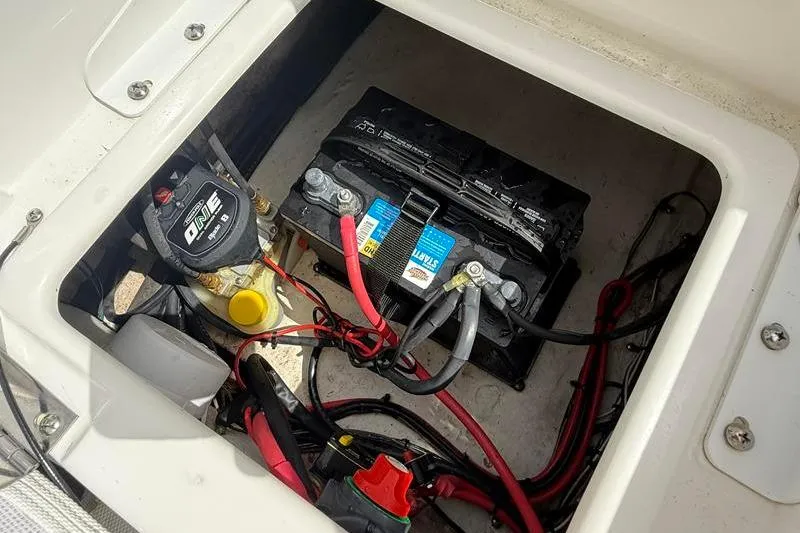 Slide: The Image of Battery compartment of 2018 Sea Hunt BX 25 FS boat with wiring and components. - 11