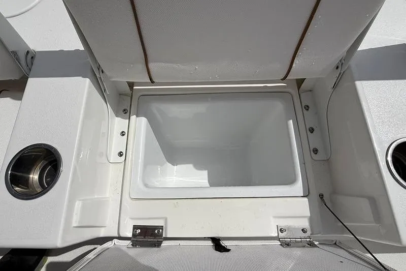 Slide: The Image of 2018 Sea Hunt BX 25 FS boat storage compartment with cup holders. - 12