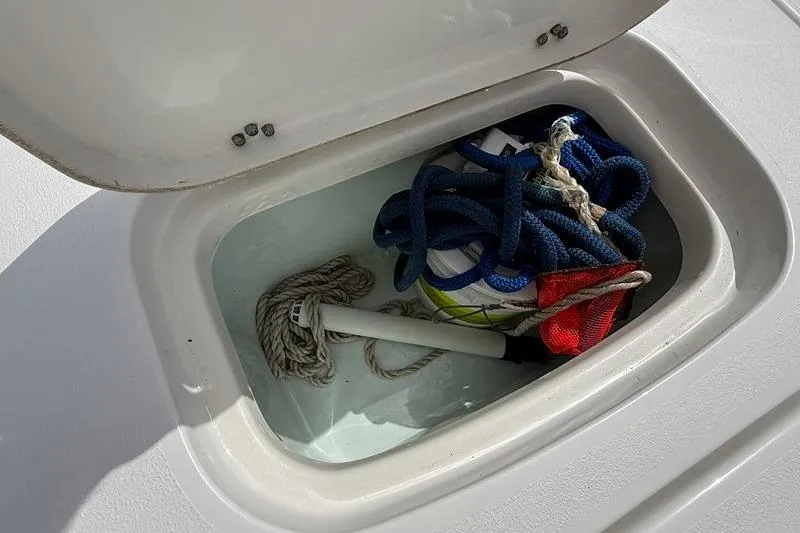 Slide: The Image of Storage compartment on a 2018 Sea Hunt BX 25 FS boat with ropes and equipment. - 16