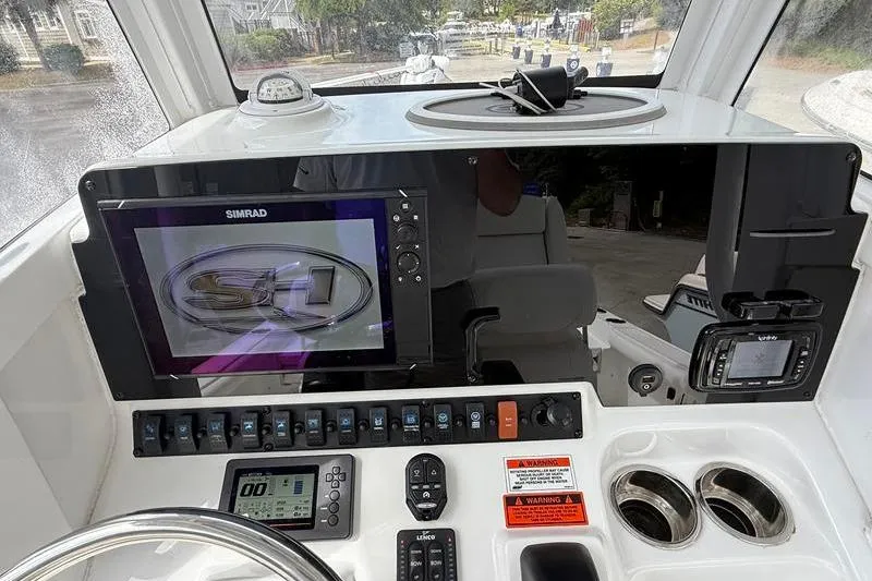 Slide: The Image of 2018 Sea Hunt BX 25 FS boat dashboard with Simrad display and control panel. - 21