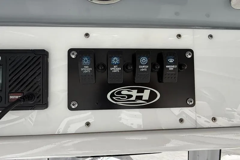 Slide: The Image of Control panel of a 2018 Sea Hunt BX 25 FS boat with labeled switches. - 27