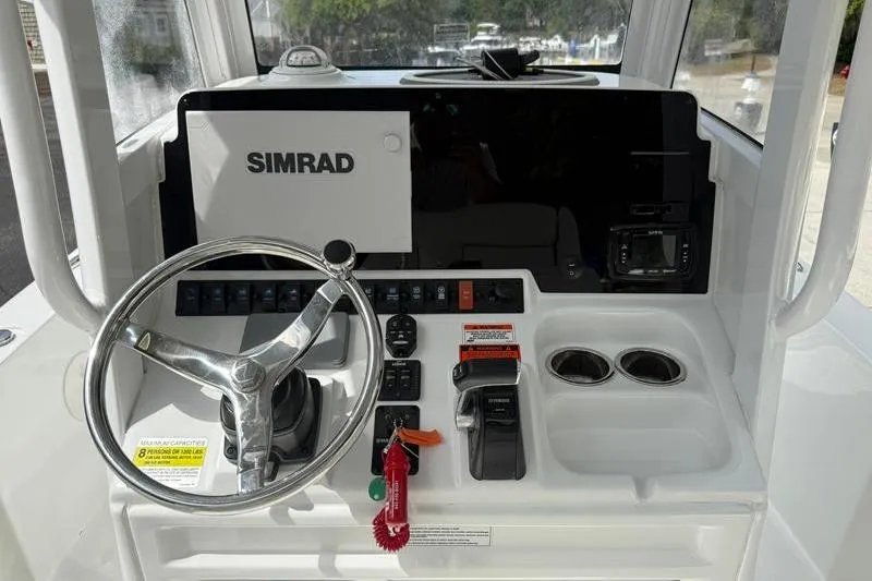 Slide: The Image of 2018 Sea Hunt BX 25 FS boat dashboard with Simrad display and steering wheel. - 28
