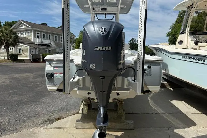 Slide: The Image of 2018 Sea Hunt BX 25 FS boat with Yamaha 300 outboard motor, docked beside another boat. - 3