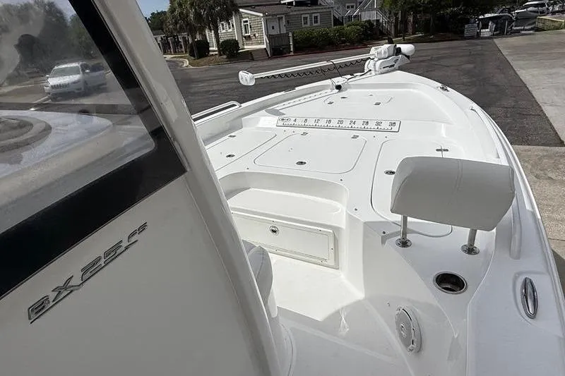 Slide: The Image of 2018 Sea Hunt BX 25 FS boat, white deck, parked in residential area. - 30