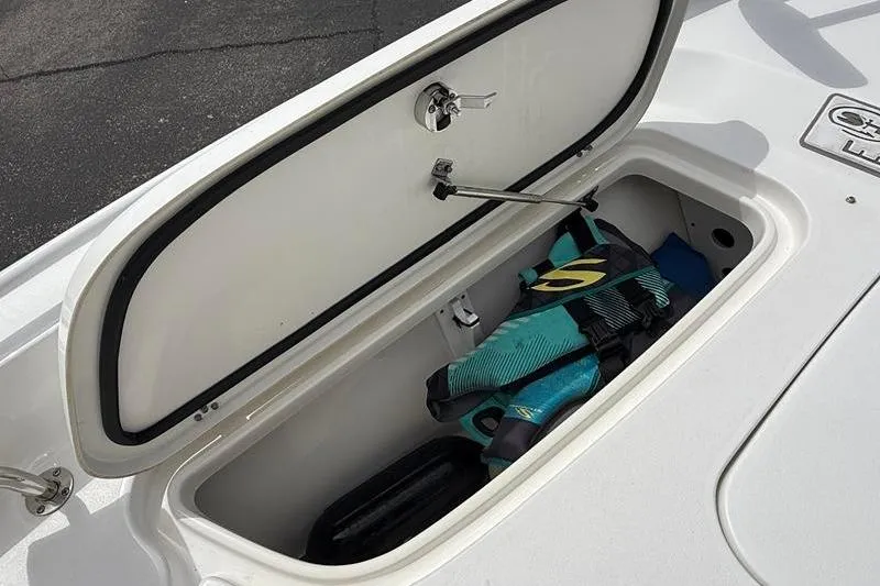 Slide: The Image of Open storage compartment on 2018 Sea Hunt BX 25 FS boat with life jacket inside. - 31