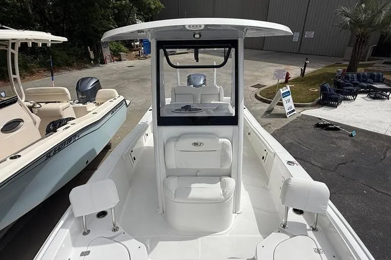 Slide: The Image of 2018 Sea Hunt BX 25 FS boat with center console and seating, displayed outdoors. - 36