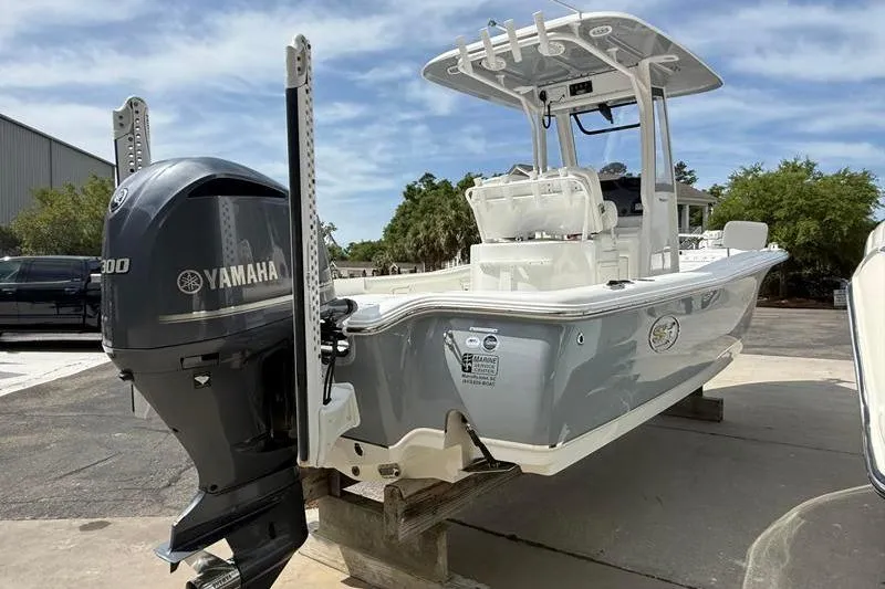 Slide: The Image of 2018 Sea Hunt BX 25 FS boat with Yamaha engine, parked outdoors. - 4