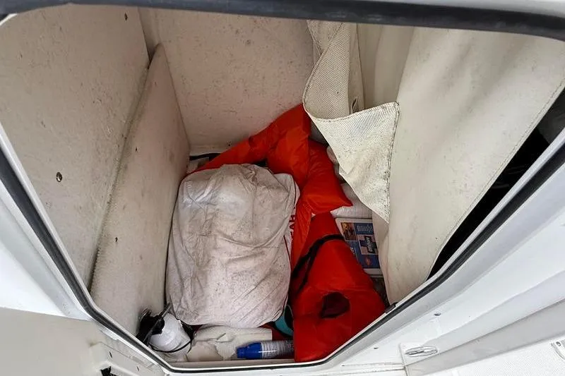 Slide: The Image of Storage compartment of a 2018 Sea Hunt BX 25 FS boat with life jackets and gear. - 40