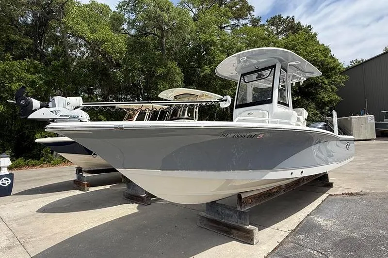 Slide: The Image of 2018 Sea Hunt BX 25 FS boat on display, parked outdoors on a sunny day. - 7