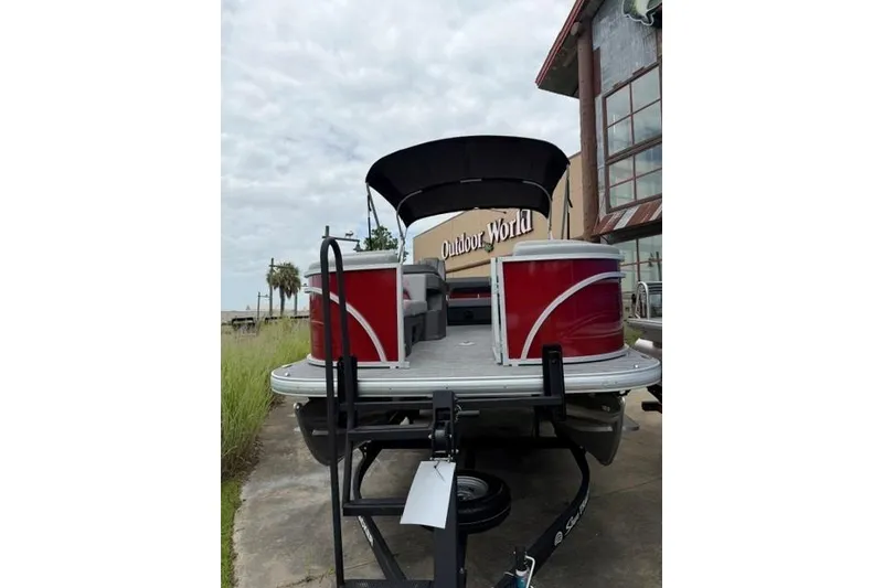 Slide: The Image of 2026 Sun Tracker Party Barge 22 RF DLX pontoon boat parked outside Outdoor World. - 3