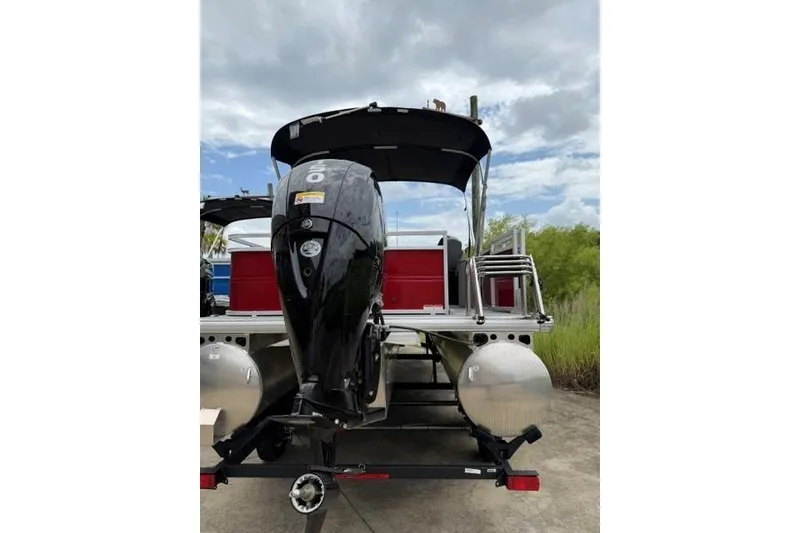 Slide: The Image of 2026 Sun Tracker Party Barge 22 RF DLX pontoon boat with outboard motor. - 2