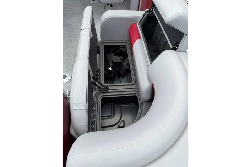 Slide: The Image of 2026 Sun Tracker Party Barge 22 RF DLX interior storage compartments open. - 10