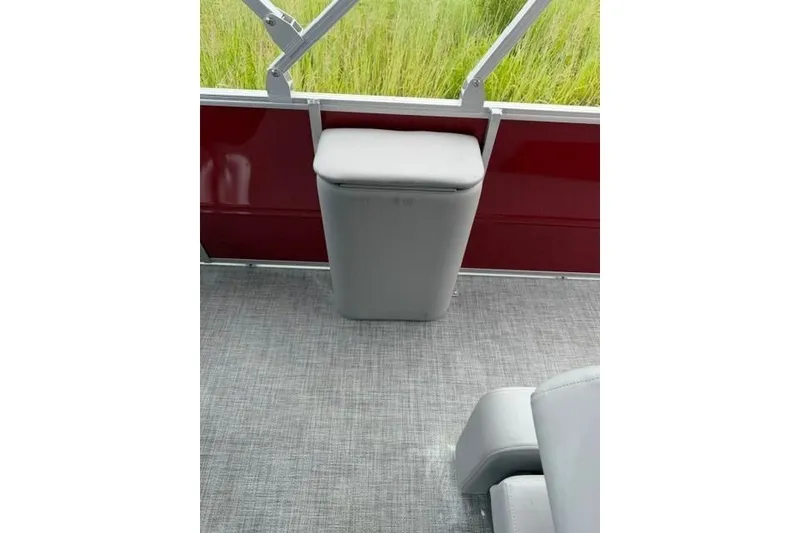 Slide: The Image of Interior of 2026 Sun Tracker Party Barge 22 RF DLX with gray seating and red paneling. - 8
