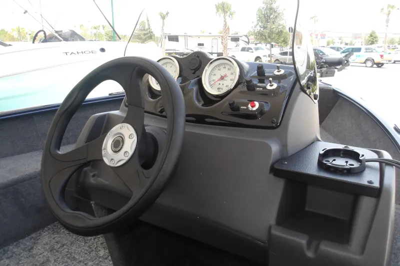 Slide: The Image of Steering console of 2026 Tracker Super Guide V-16 SC boat with gauges and controls. - 11