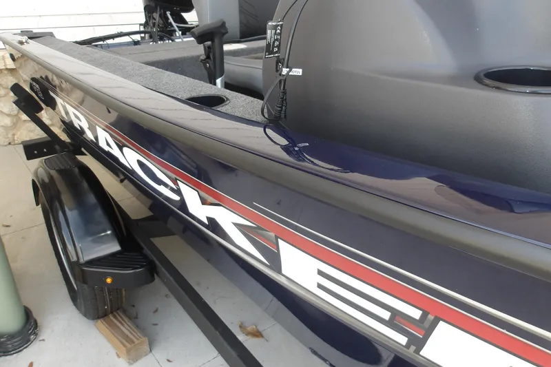 Slide: The Image of 2026 Tracker Super Guide V-16 SC boat, close-up view of sleek design and branding. - 13