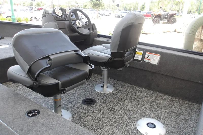 Slide: The Image of Interior of 2026 Tracker Super Guide V-16 SC boat with swivel seats and dashboard. - 6