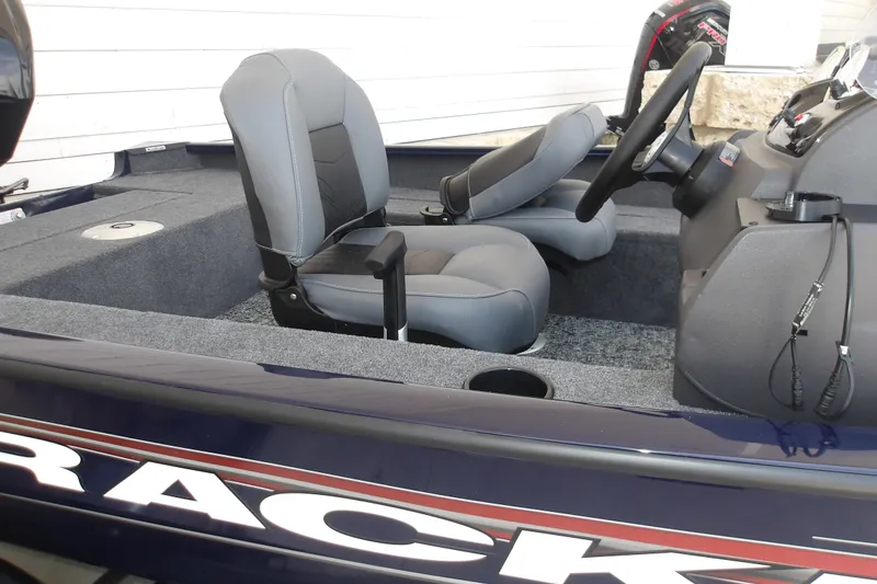Slide: The Image of 2026 Tracker Super Guide V-16 SC boat interior with gray seating and steering console. - 12