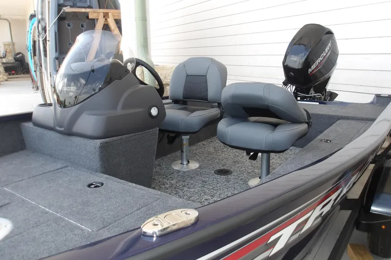 The Image of 2026 Tracker Super Guide V-16 SC boat interior with seating and Mercury outboard motor. - 1