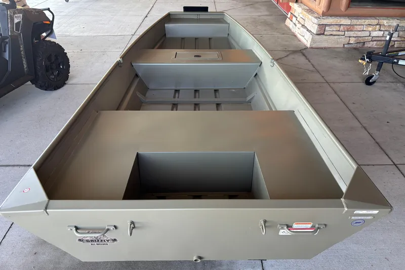 Slide: The Image of 2026 Tracker Grizzly 15 Jon boat displayed on concrete floor. - 2