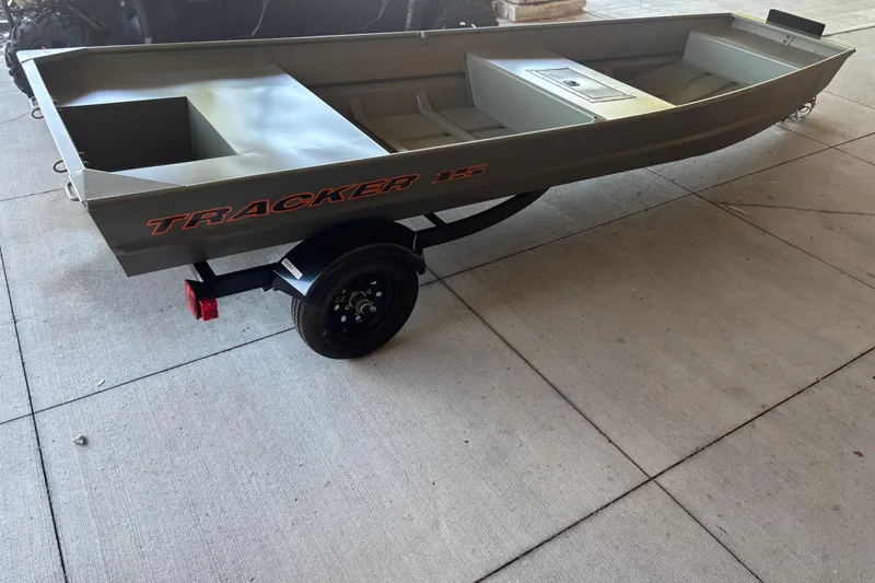 Slide: The Image of 2026 Tracker Grizzly 15 Jon boat on trailer, displayed outdoors. - 3