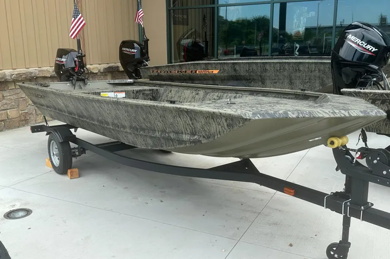 Slide: The Image of 2026 Tracker Grizzly 1648 Utility boat on trailer, featuring Mercury outboard motors. - 2