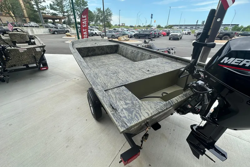 Slide: The Image of 2026 Tracker Grizzly 1648 Utility boat with camouflage design and Mercury outboard motor. - 5