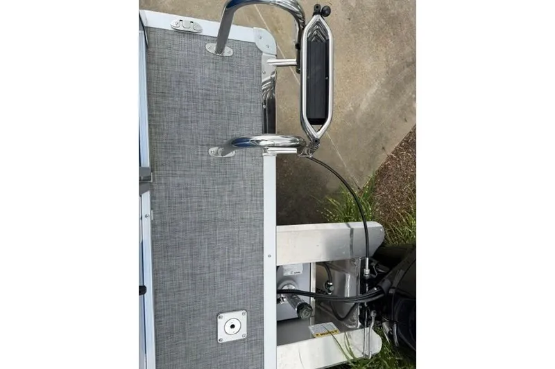 Slide: The Image of 2026 Sun Tracker Party Barge 22 RF DLX boat deck with ladder and motor components. - 13