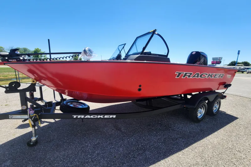 The Image of 2026 Tracker Targa V-19 Combo boat in vibrant red on a trailer, outdoors. - 0