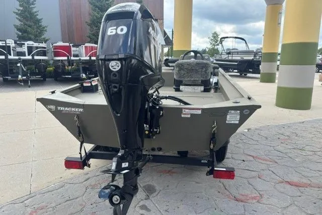 Slide: The Image of 2026 Tracker Grizzly 1754 SC boat with 60 HP motor, parked outdoors. - 4