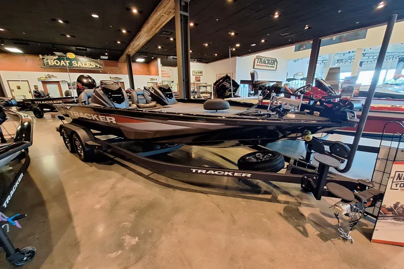 The Image of 2026 Tracker Savage 215 boat displayed in a showroom, highlighting sleek design and modern features. - 0