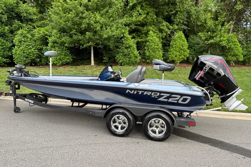 Slide: The Image of 2026 Nitro Z20 XL boat on trailer, parked on road with lush green background. - 4