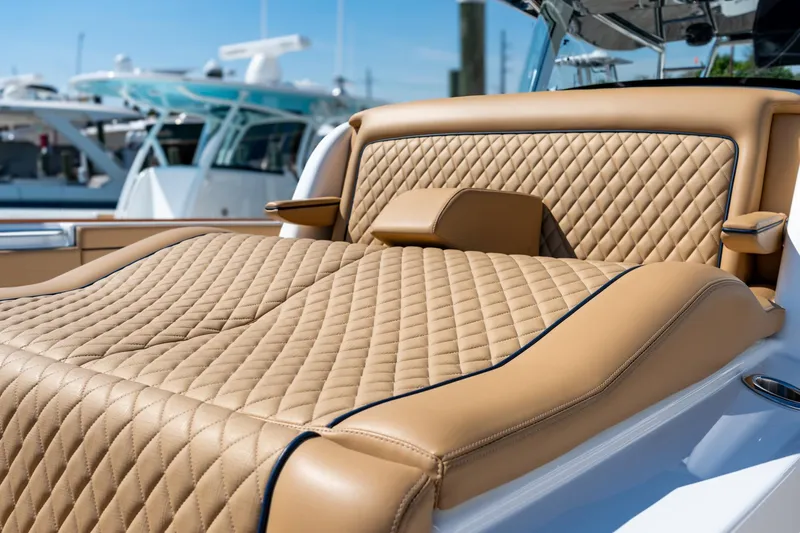 Slide: The Image of Luxurious tan seating on 2023 Valhalla Boatworks V-46, featuring diamond-stitched upholstery. - 12