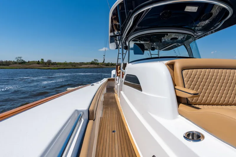 Slide: The Image of 2023 Valhalla Boatworks V-46 cruising on a sunny day, showcasing luxurious seating and sleek design. - 14