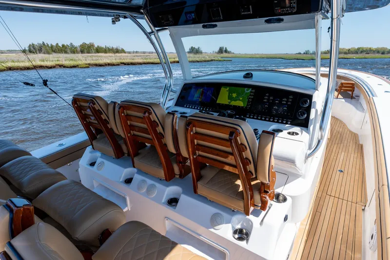 Slide: The Image of 2023 Valhalla Boatworks V-46 helm with advanced navigation system and luxurious seating. - 17