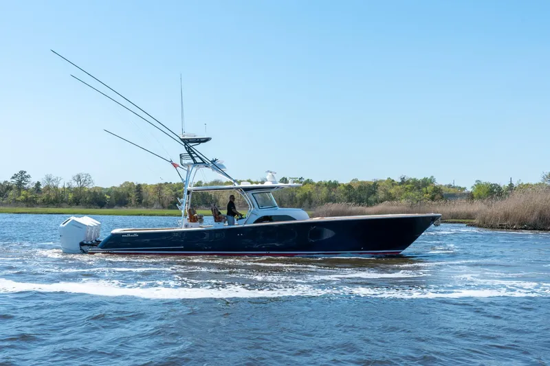 Slide: The Image of 2023 Valhalla Boatworks V-46 cruising on a calm river under clear blue skies. - 2
