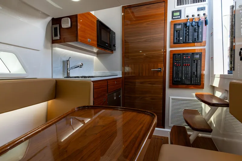 Slide: The Image of Luxurious interior of 2023 Valhalla Boatworks V-46, featuring wood finishes and modern amenities. - 28