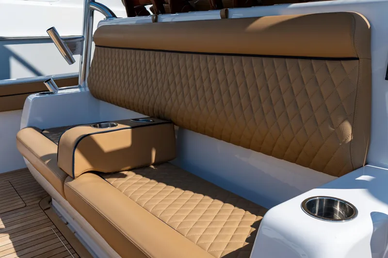 Slide: The Image of 2023 Valhalla Boatworks V-46 interior with tan quilted seating and cup holders. - 31