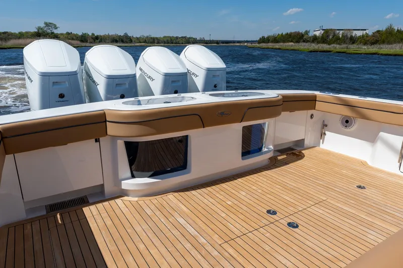 Slide: The Image of 2023 Valhalla Boatworks V-46 with quad Mercury engines on a serene waterway. - 33
