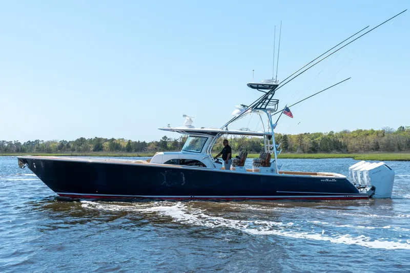 Slide: The Image of 2023 Valhalla Boatworks V-46 cruising on a calm river with lush green shoreline. - 4