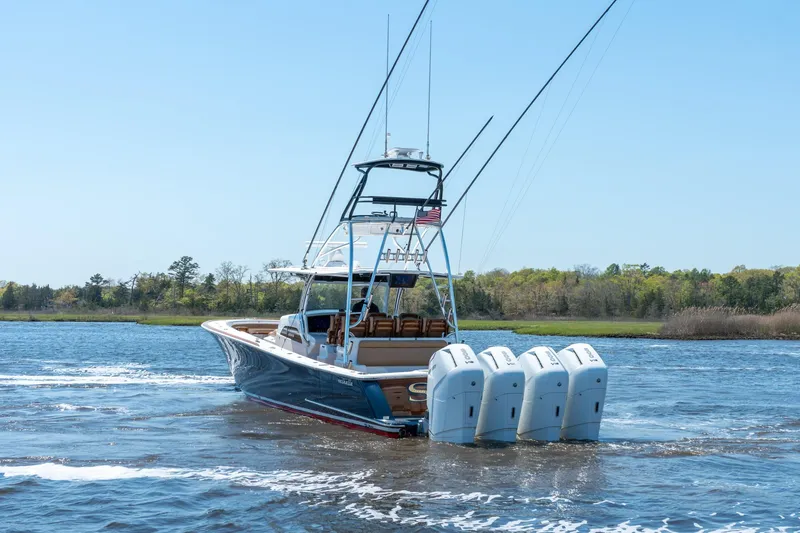 Slide: The Image of 2023 Valhalla Boatworks V-46 cruising on a serene waterway with four engines. - 6