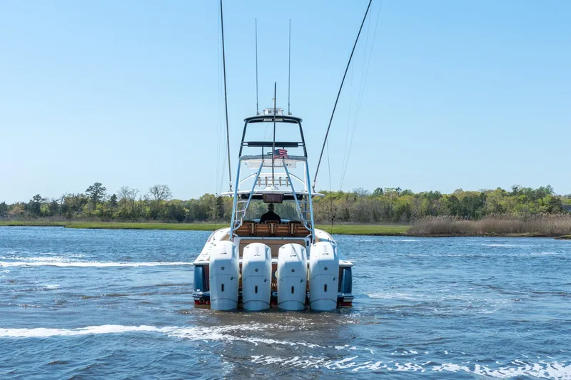 Slide: The Image of 2023 Valhalla Boatworks V-46 cruising on a scenic river with lush greenery. - 7