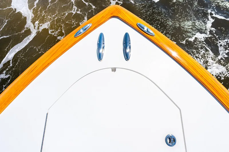 Slide: The Image of Bow of 2023 Valhalla Boatworks V-46 with teak accents on water. - 8