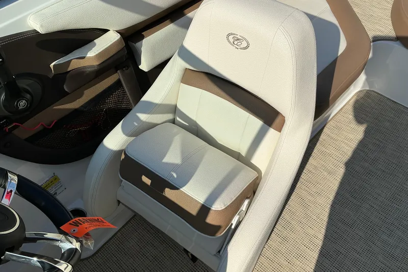 Slide: The Image of 2019 Cobalt CS23 boat interior with beige and brown seating. - 15