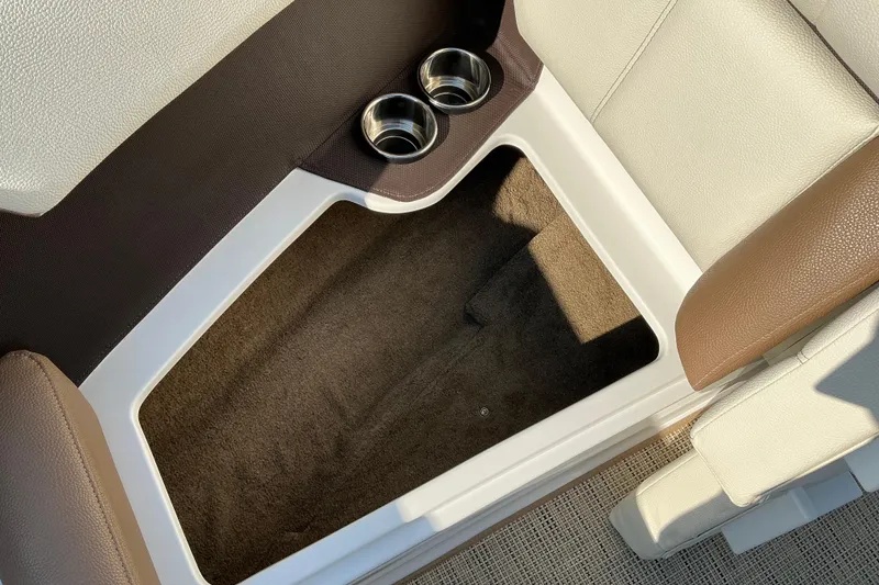 Slide: The Image of 2019 Cobalt CS23 boat interior with cup holders and storage compartment. - 16