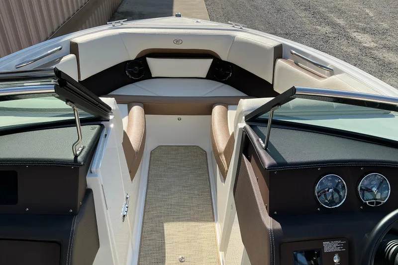 Slide: The Image of 2019 Cobalt CS23 boat interior with beige seating and dashboard gauges. - 6