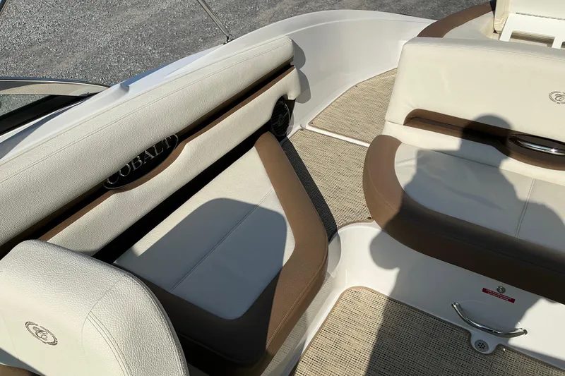 Slide: The Image of Interior of a 2019 Cobalt CS23 boat with beige and brown seating. - 8