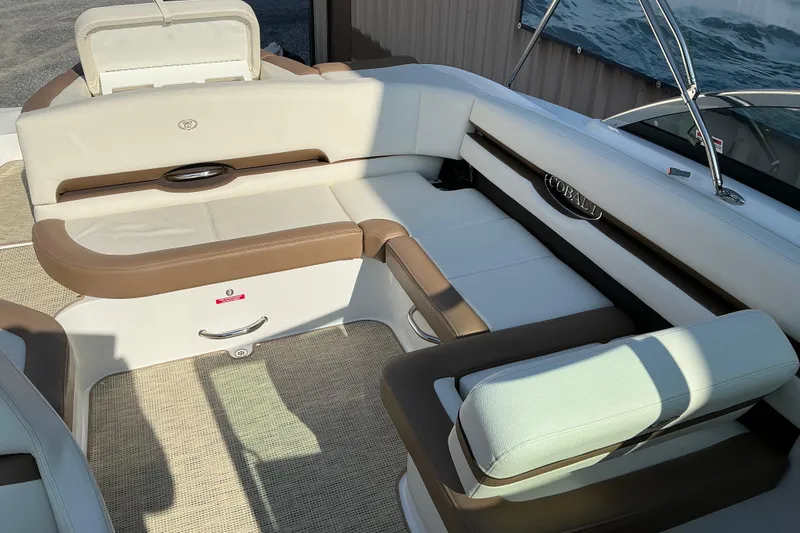 Slide: The Image of Luxurious seating area on a 2019 Cobalt CS23 boat, featuring beige and white upholstery. - 9