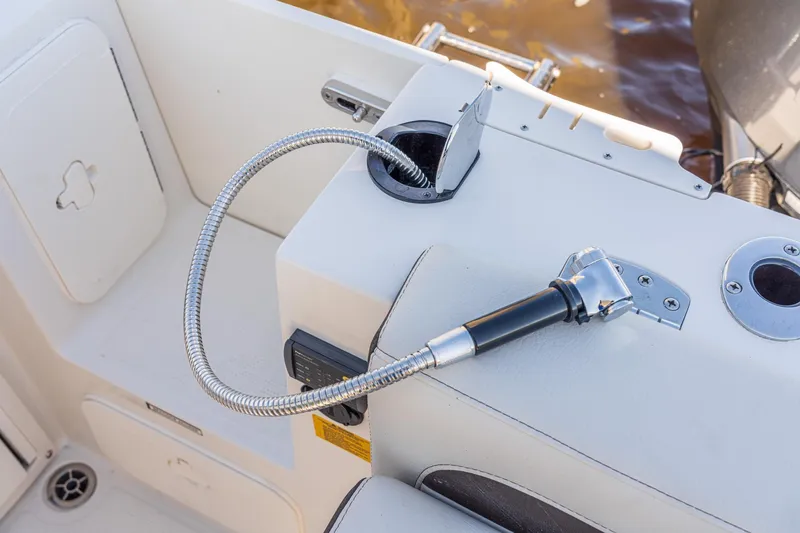 Slide: The Image of Sailfish 245 DC 2027 boat deck with flexible hose and fittings. - 14
