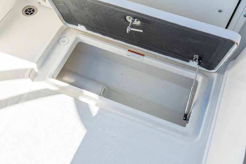 Slide: The Image of Open storage compartment on 2027 Sailfish 245 DC boat deck. - 16