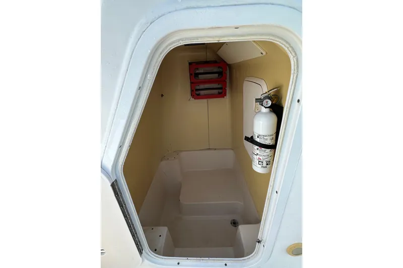 Slide: The Image of 2008 Pro-Line 20 Sport boat interior with fire extinguisher and storage compartment. - 10
